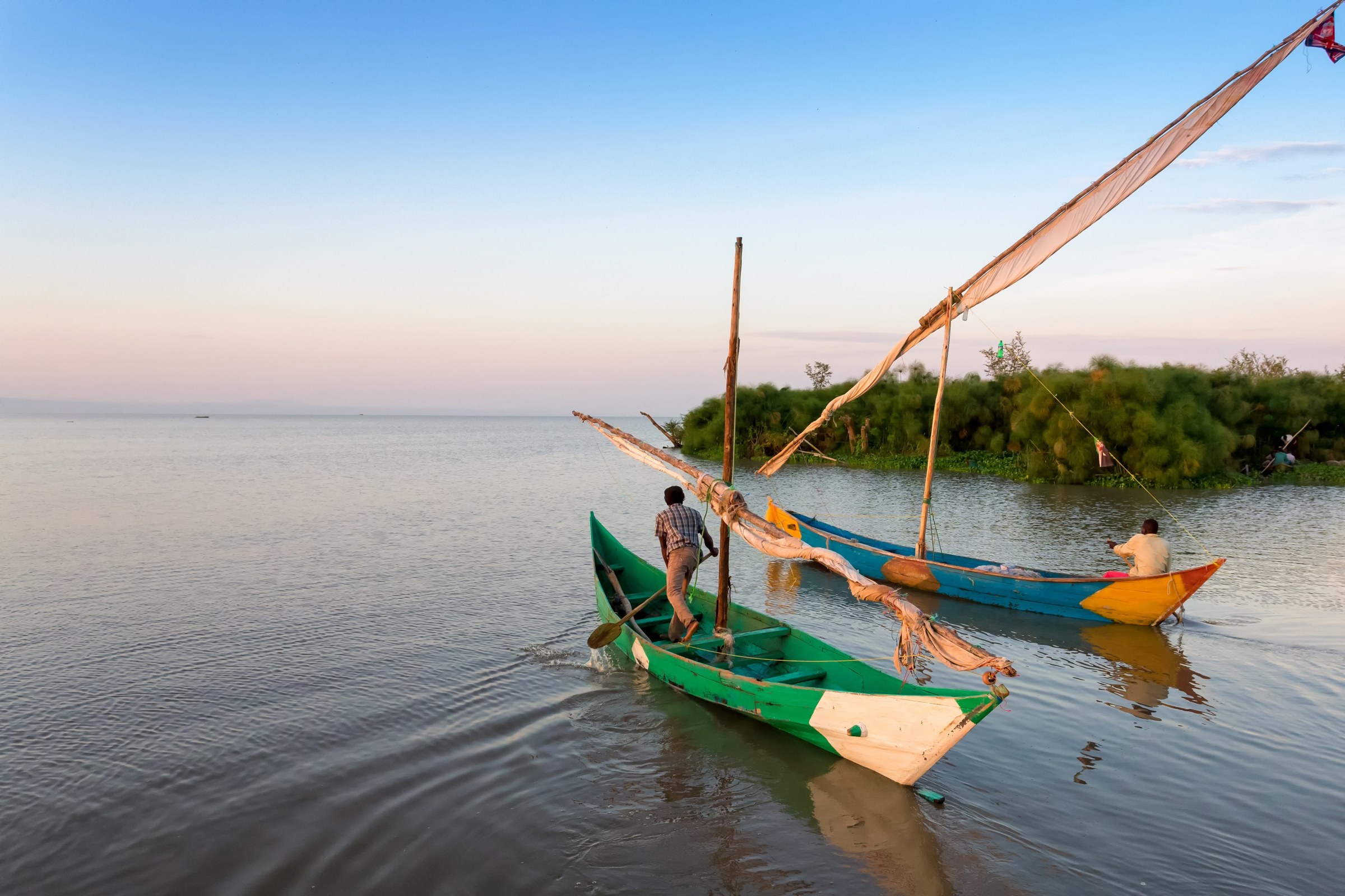 Fishermen with a sailed wooden boat on Lake Victoria